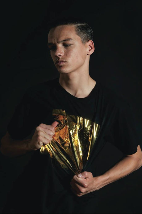  modelswearing gold and black outfits.