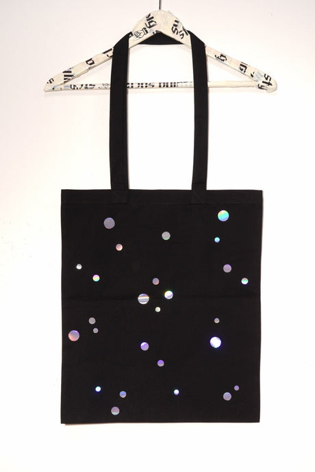 black tote bag with spectral color dots in 3 different sizes backside