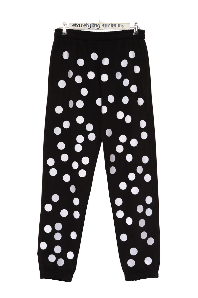Printed black joggers with reflective polka dots on front and back