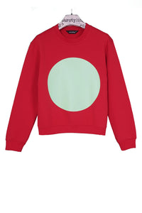 Red jumper with a big aqua green circle in the middle