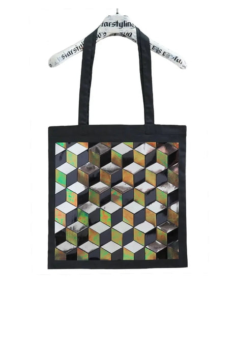 Geometric patterned tote bag with black handles and reflective cube design