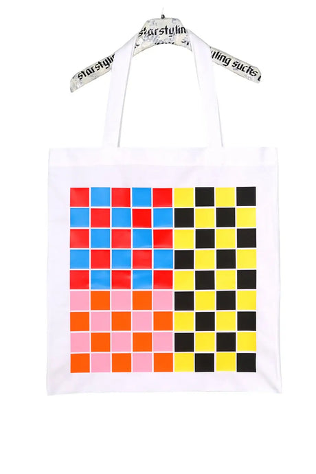 White tote bag with colorful pixel pattern blocks in blue, red, orange, pink, yellow, and black.