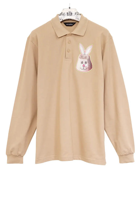 Beige long sleeve polo shirt with a playful bunny face graphic on the chest