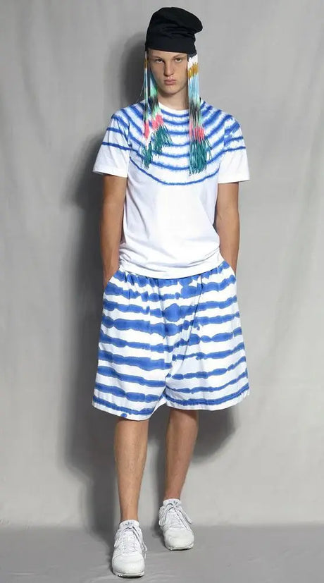 Model in hand-painted blue and white Bermuda shorts with matching striped t-shirt