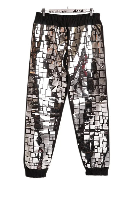 Black joggers with shiny mosaic mirror print and elastic waistband, displayed on hanger