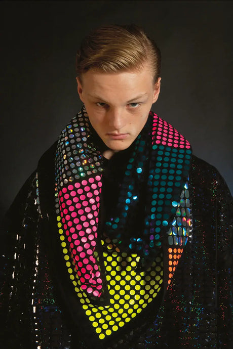 Model wearing a colorful, polka dot patterned scarf with neon accents on a black base.