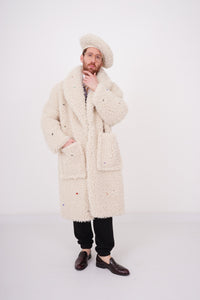 Teddy fake fur coat in creme color with stones, charms and funny buttons sewn allover